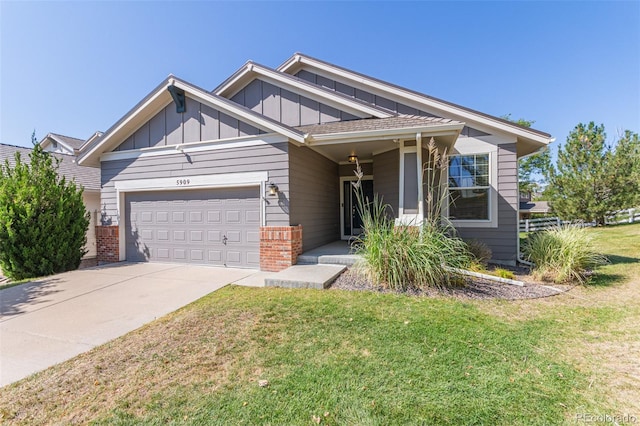 craftsman inspired home with a garage and a front lawn