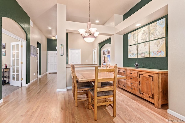 dining room featuring light wood-type flooring and a chandelier