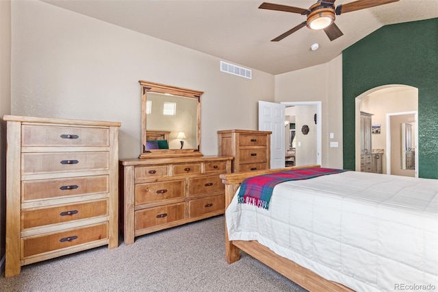 carpeted bedroom with vaulted ceiling, ensuite bathroom, and ceiling fan