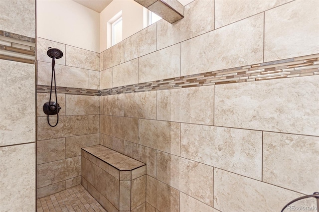 bathroom with tiled shower