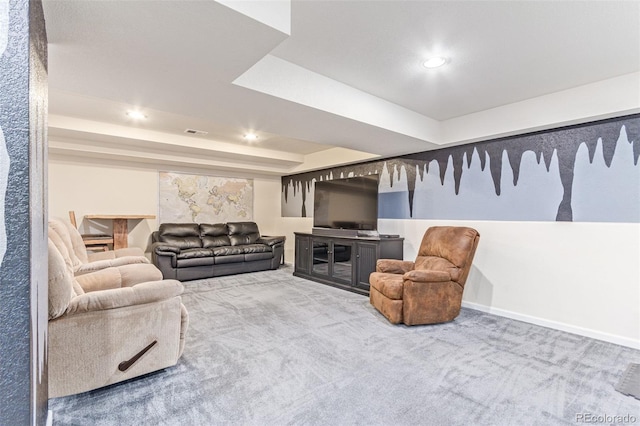 carpeted living room featuring a tray ceiling