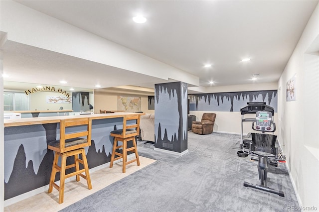 workout room with light carpet and bar area