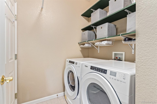 clothes washing area featuring washing machine and dryer and light tile patterned flooring