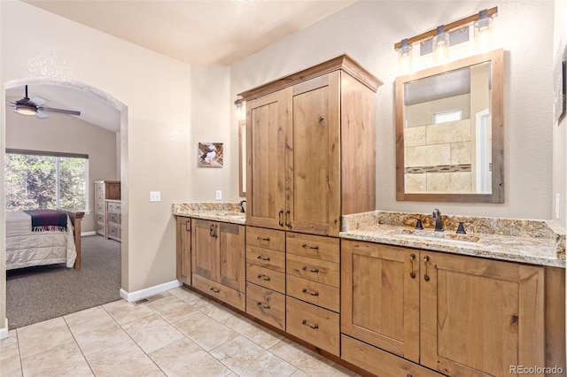 bathroom featuring lofted ceiling, vanity, ceiling fan, and tile patterned floors