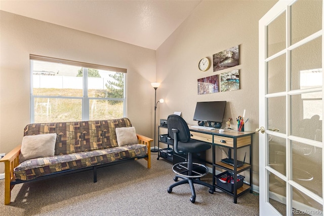 home office featuring lofted ceiling and carpet