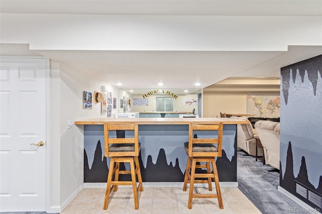 kitchen with kitchen peninsula and tile patterned flooring