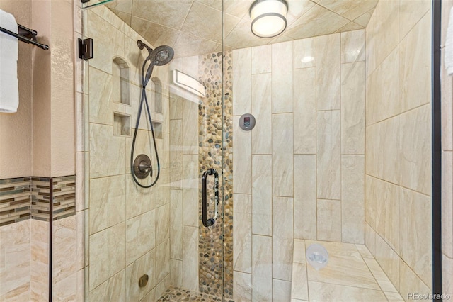 bathroom featuring a shower with shower door