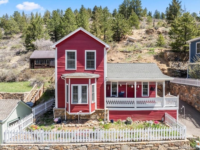 151 Marchant St, Black Hawk, CO 80422 - view of front of house featuring a fenced front yard, a porch, and roof with shingles