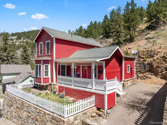 151 Marchant St, Black Hawk, CO 80422 - view of front facade featuring fence, a shingled roof, and covered porch