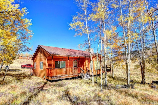 back of house featuring a deck