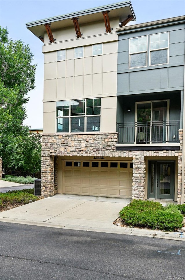 13524 Via Varra, Broomfield, CO 80020 - view of front of property with stone siding, an attached garage, driveway, and stucco siding