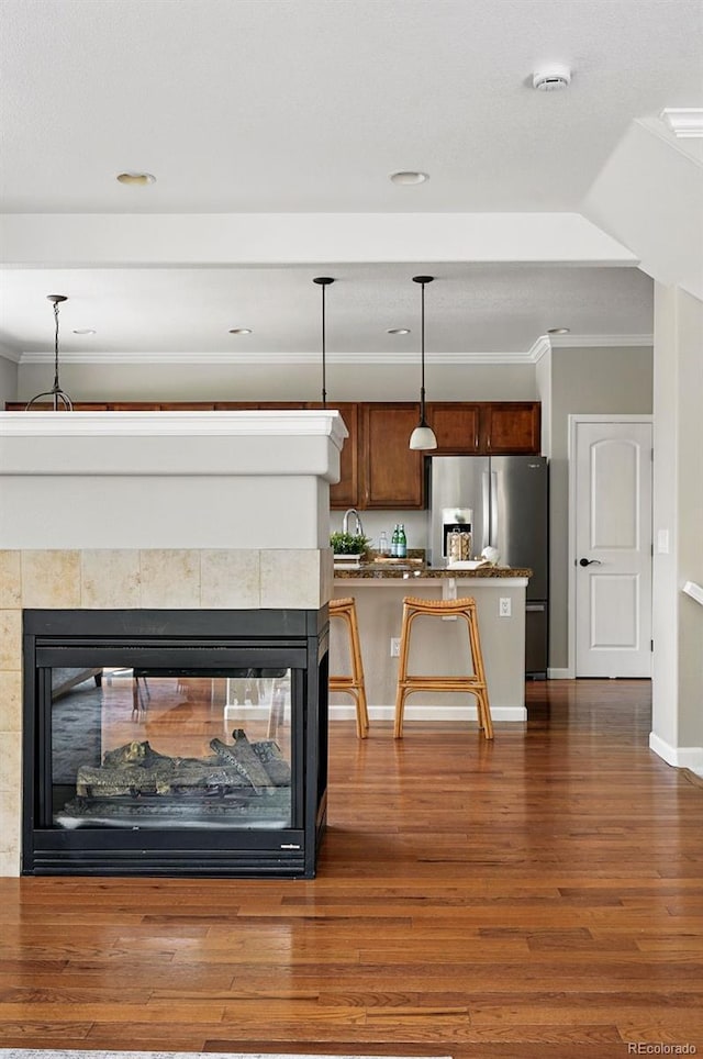 13524 Via Varra, Broomfield, CO 80020 - living room with dark wood-style flooring, crown molding, baseboards, recessed lighting, and a multi sided fireplace