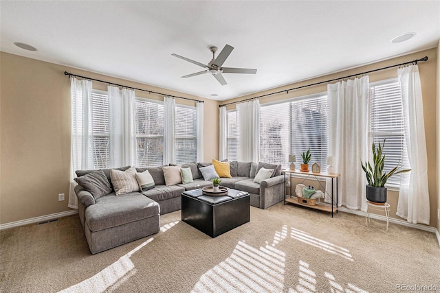 carpeted living room with ceiling fan