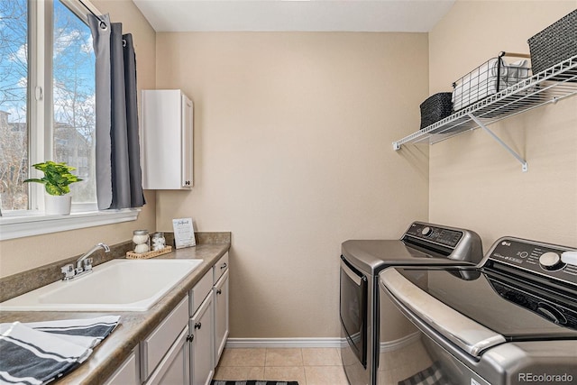 laundry area with independent washer and dryer, light tile patterned floors, plenty of natural light, and sink