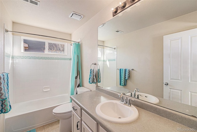 full bathroom featuring tile patterned floors, a textured ceiling, vanity, shower / bath combo with shower curtain, and toilet