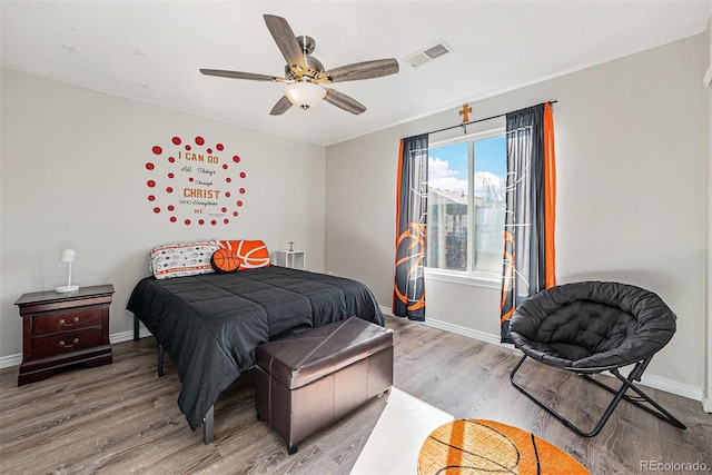 bedroom with ceiling fan and hardwood / wood-style flooring