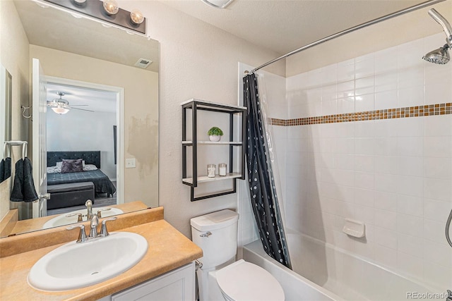 full bathroom featuring vanity, ceiling fan, toilet, and shower / tub combo with curtain