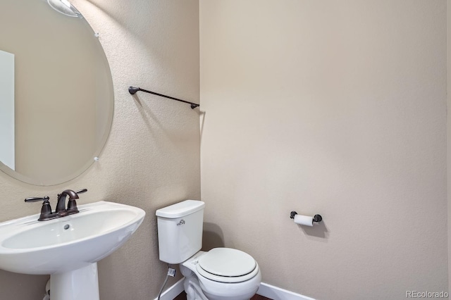 bathroom with toilet and sink