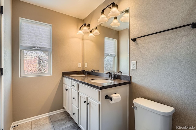 bathroom with tile patterned floors, vanity, and toilet