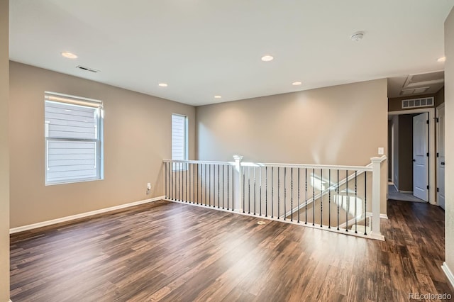 empty room featuring dark hardwood / wood-style flooring