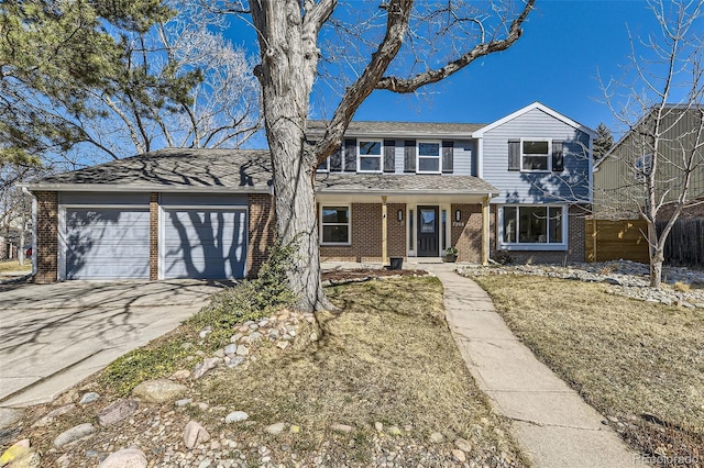 traditional-style house with concrete driveway, brick siding, and an attached garage