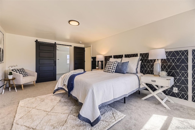 bedroom featuring carpet floors and a barn door