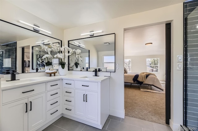 ensuite bathroom featuring double vanity, tile patterned flooring, ensuite bath, and a sink