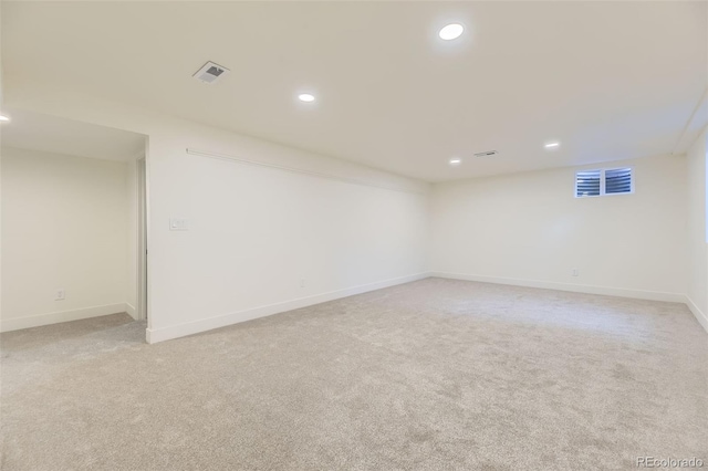 unfurnished room with baseboards, recessed lighting, visible vents, and light colored carpet