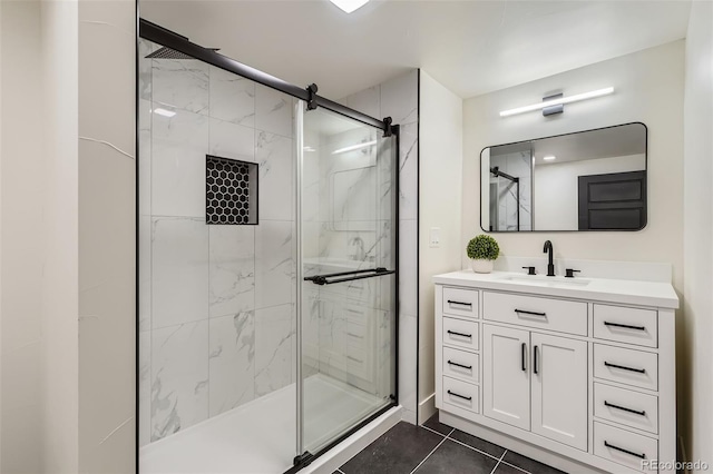 full bathroom with a shower stall, vanity, and tile patterned floors