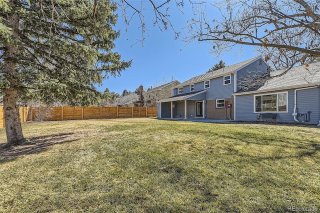 view of yard with a patio area and a fenced backyard