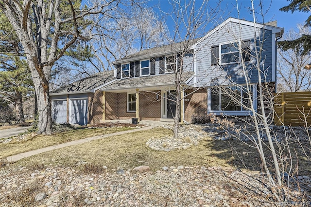 traditional-style home featuring a garage and brick siding