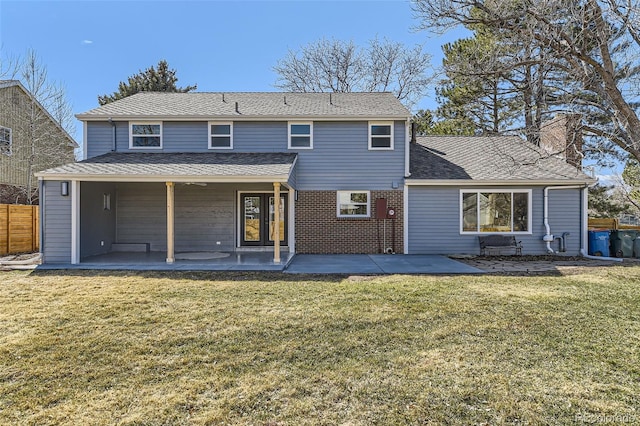 rear view of house featuring a patio area, a chimney, fence, and a yard