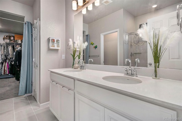 bathroom featuring vanity, tile patterned flooring, and a shower with door