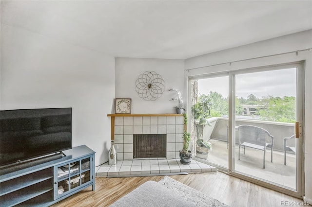 3240 Iris Ave Unit G409, Boulder, CO 80301 - living area featuring a tiled fireplace and wood finished floors
