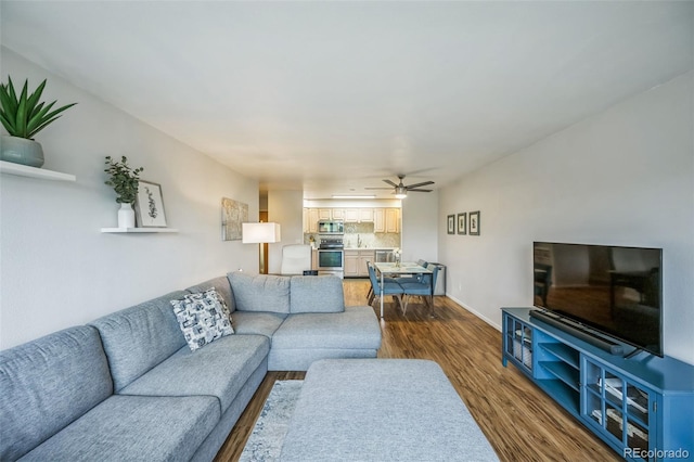 3240 Iris Ave Unit G409, Boulder, CO 80301 - living room with dark wood-style floors, a ceiling fan, and baseboards