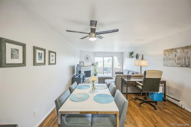 3240 Iris Ave Unit G409, Boulder, CO 80301 - dining room with a baseboard heating unit, wood finished floors, baseboards, and a ceiling fan