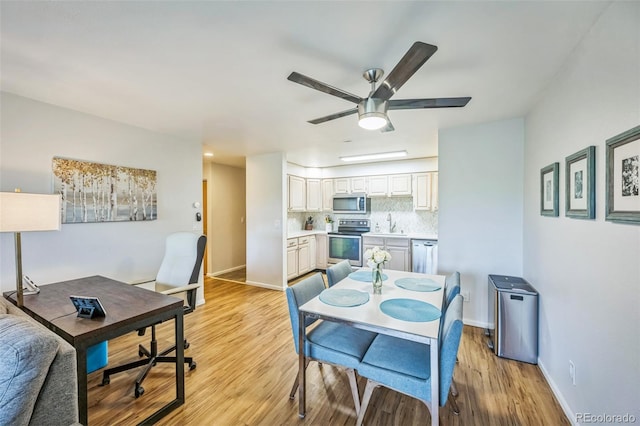 3240 Iris Ave Unit G409, Boulder, CO 80301 - dining room with a ceiling fan, light wood finished floors, and baseboards
