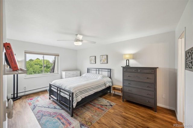 3240 Iris Ave Unit G409, Boulder, CO 80301 - bedroom with a baseboard heating unit, wood finished floors, ceiling fan, and baseboards