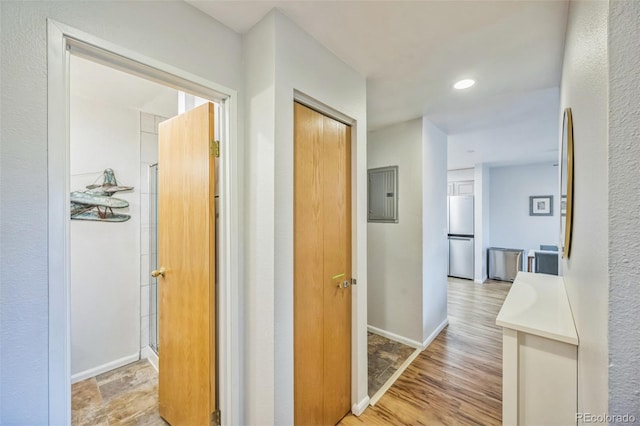 3240 Iris Ave Unit G409, Boulder, CO 80301 - corridor featuring electric panel, light wood finished floors, and recessed lighting