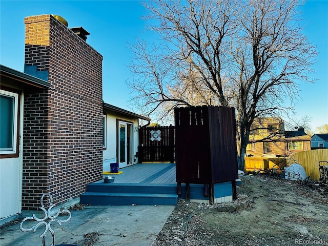 exterior space featuring fence and a deck