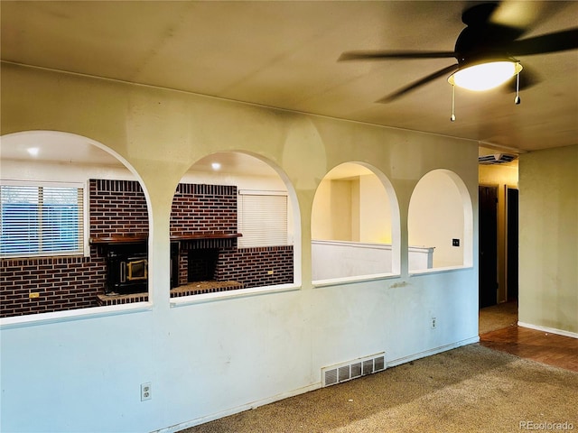 spare room with ceiling fan, carpet flooring, and visible vents