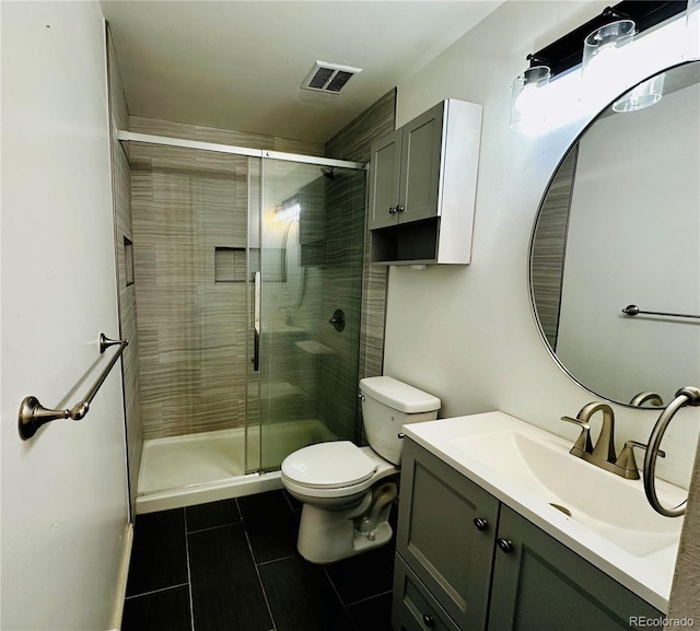 bathroom with toilet, a stall shower, visible vents, and vanity