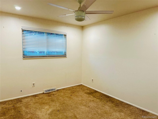 unfurnished room with baseboards, carpet, visible vents, and a ceiling fan