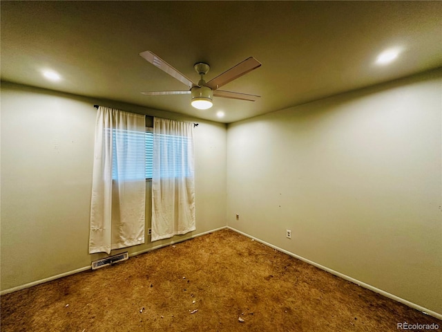 carpeted empty room featuring ceiling fan, visible vents, and baseboards