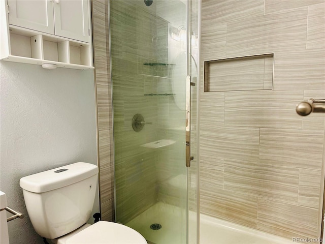 full bathroom with a shower stall and toilet