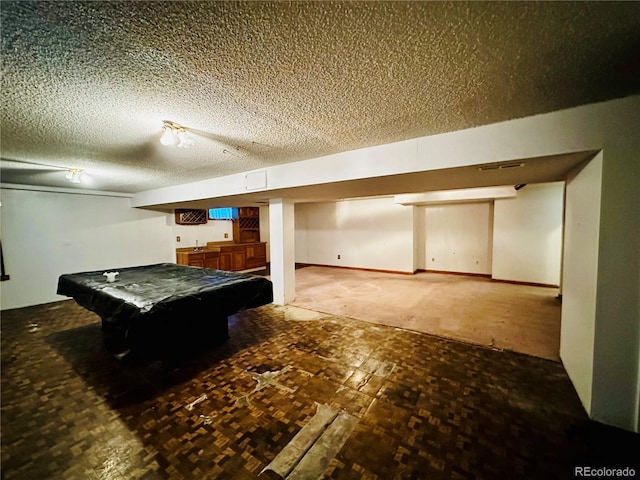 recreation room featuring pool table, a textured ceiling, and baseboards