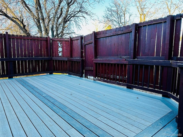 wooden terrace featuring fence