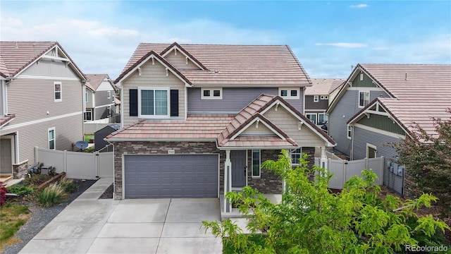 5061 Ironwood Ln, Johnstown, CO 80534 - craftsman-style home featuring a garage, driveway, a tile roof, and stone siding