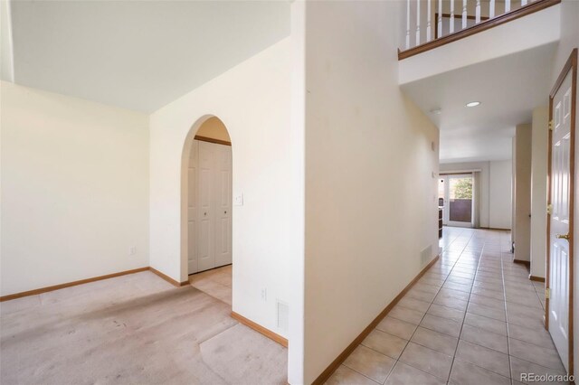 174 Luxury Ln, Colorado Springs, CO 80921 - corridor featuring arched walkways and light tile patterned flooring