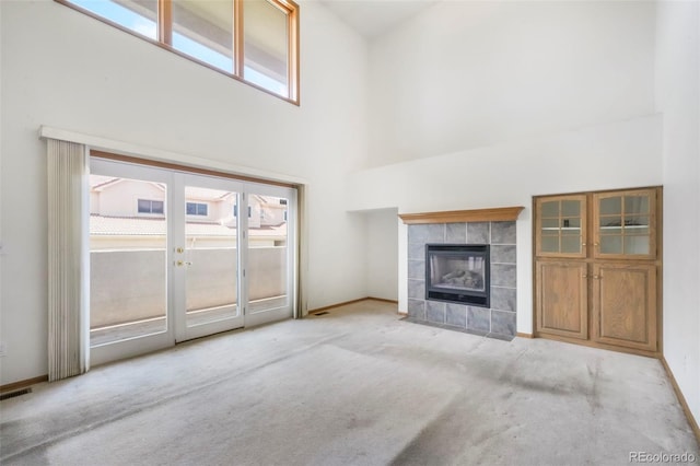 174 Luxury Ln, Colorado Springs, CO 80921 - unfurnished living room with carpet, a fireplace, and a high ceiling